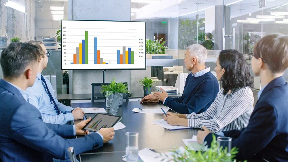 Departments comparing different customer numbers in a meeting